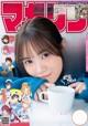 A magazine with a girl holding a cup of coffee.