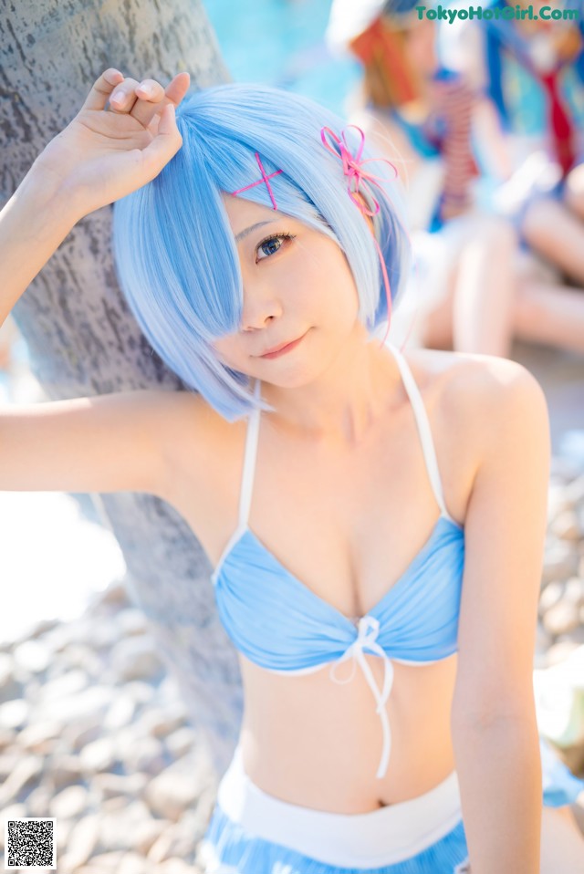 A woman in a blue bikini posing for a picture.